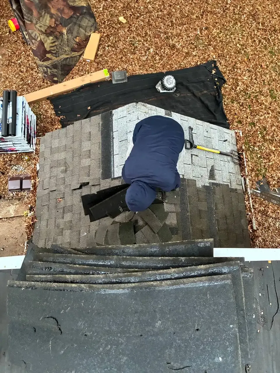 Roofing contractor installing asphalt shingles on a residential roof in St. Louis, MO