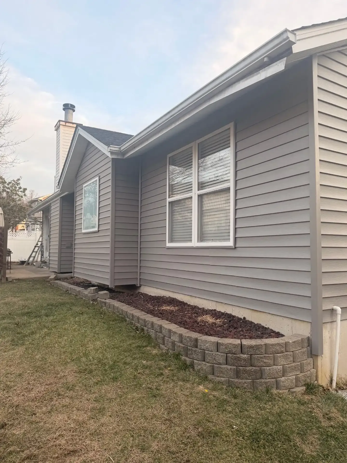 Gray vinyl siding installation on a St. Louis home