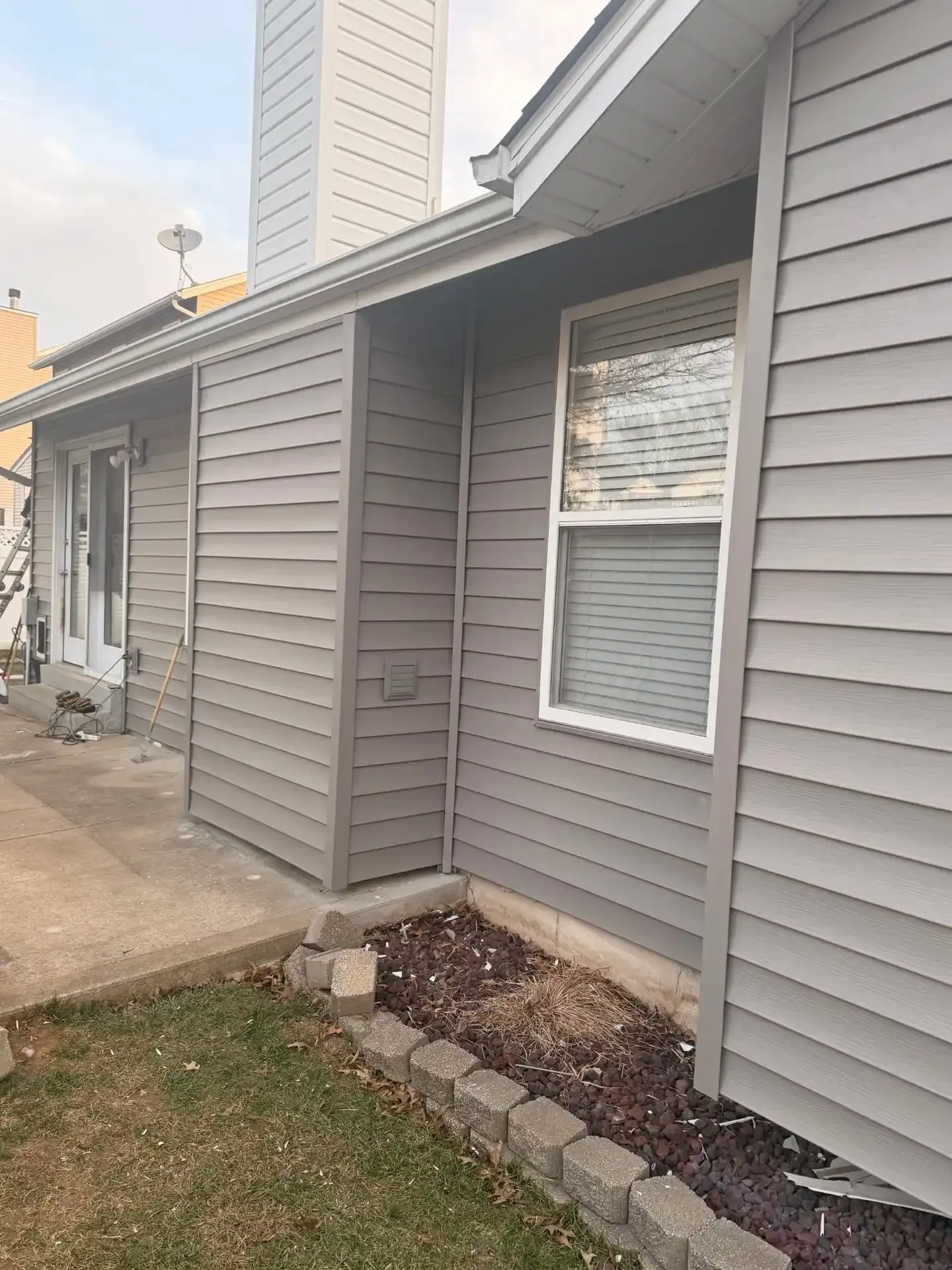Newly installed gray vinyl siding