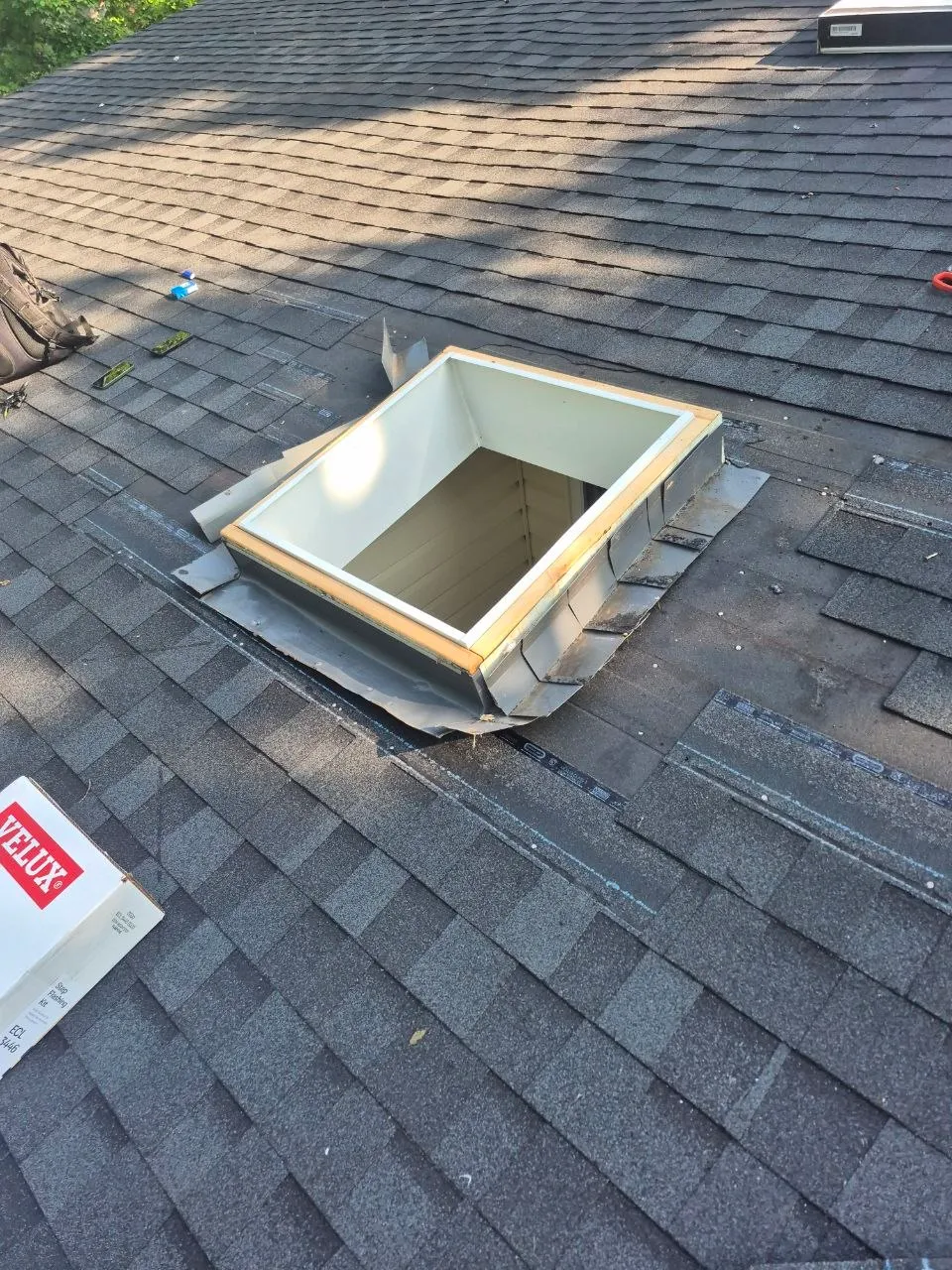 Velux skylight installation in progress on asphalt shingle roof in St. Louis, MO