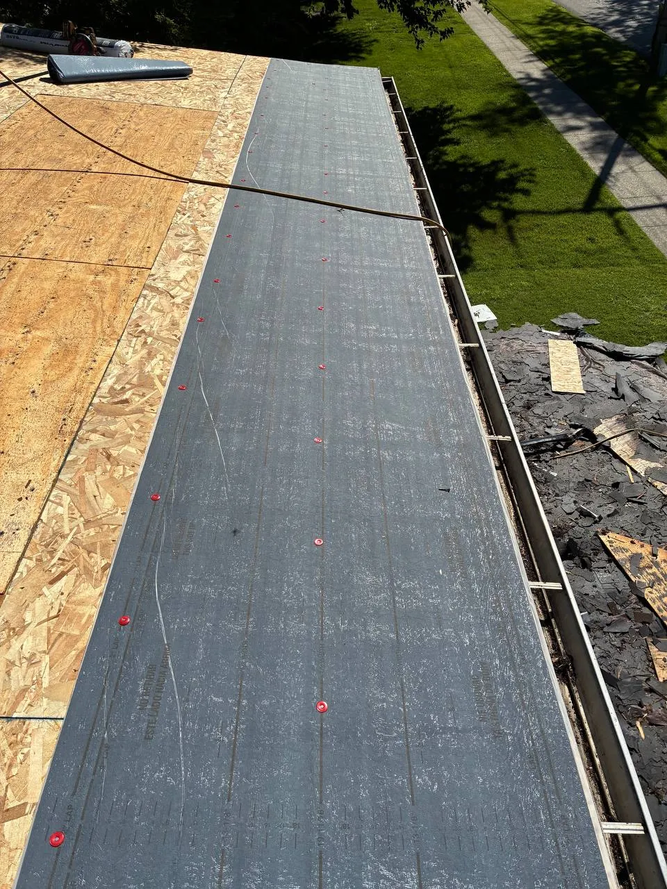 Ice and water shield membrane installed along the eave edge of a roof deck during a St. Louis re-roofing job.