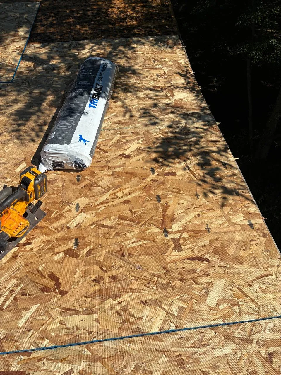Roof valley during replacement with self-adhering ice and water shield and synthetic underlayment installed over OSB decking.