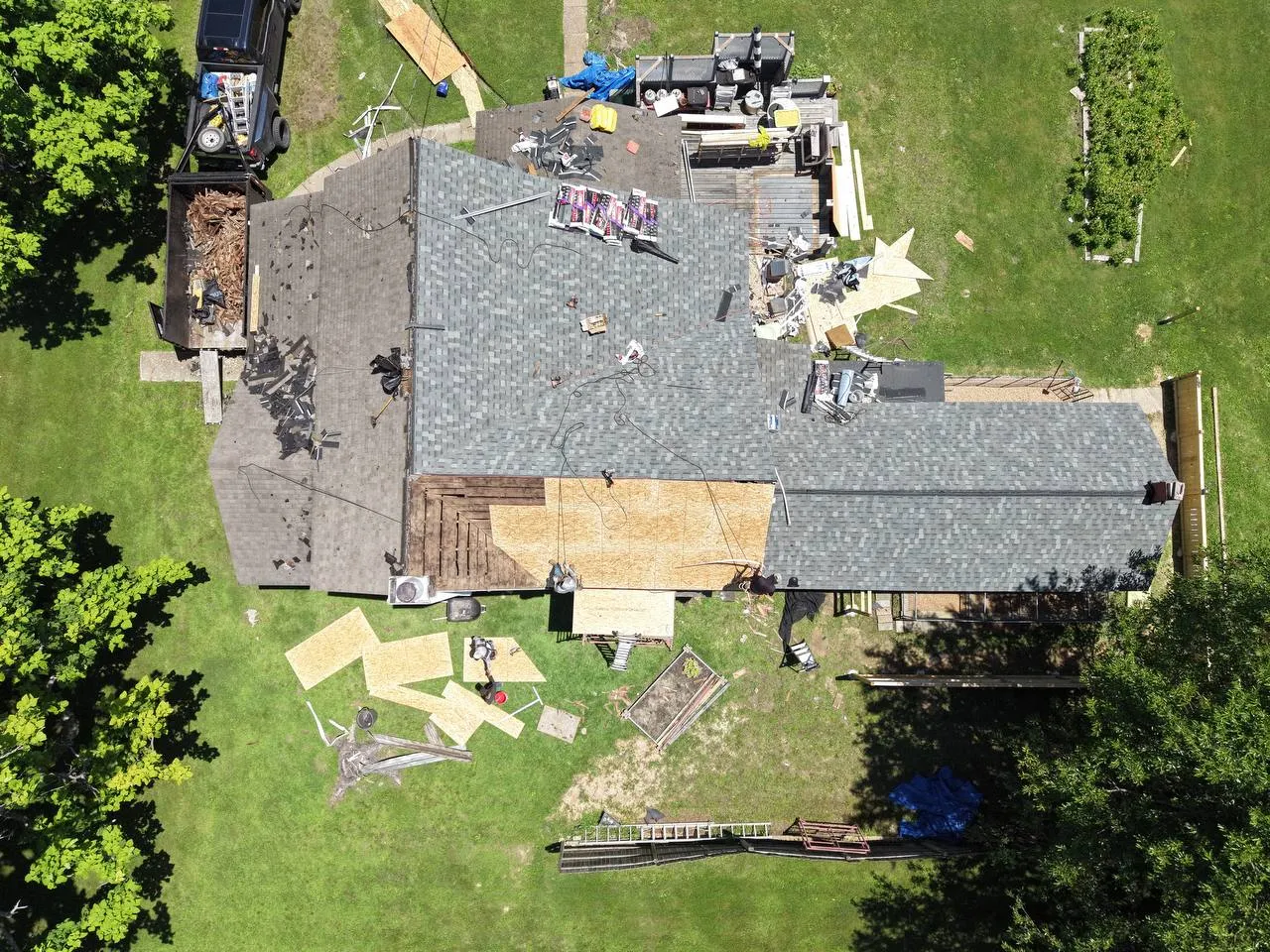 Aerial drone view of residential home undergoing roofing and construction renovation in St. Louis, MO