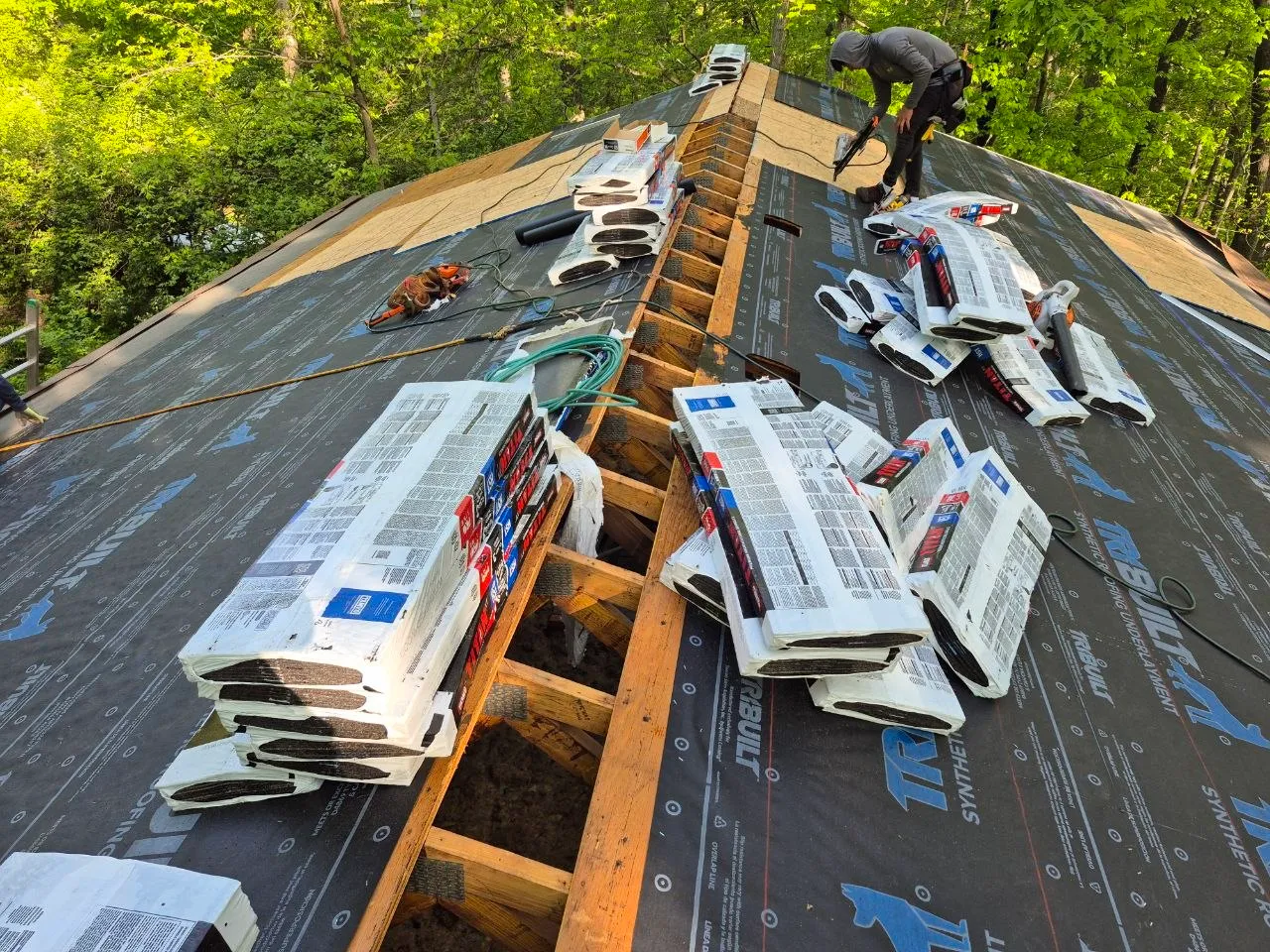 Synthetic roofing underlayment installed over new decking with shingle bundles staged for installation on a St. Louis home.