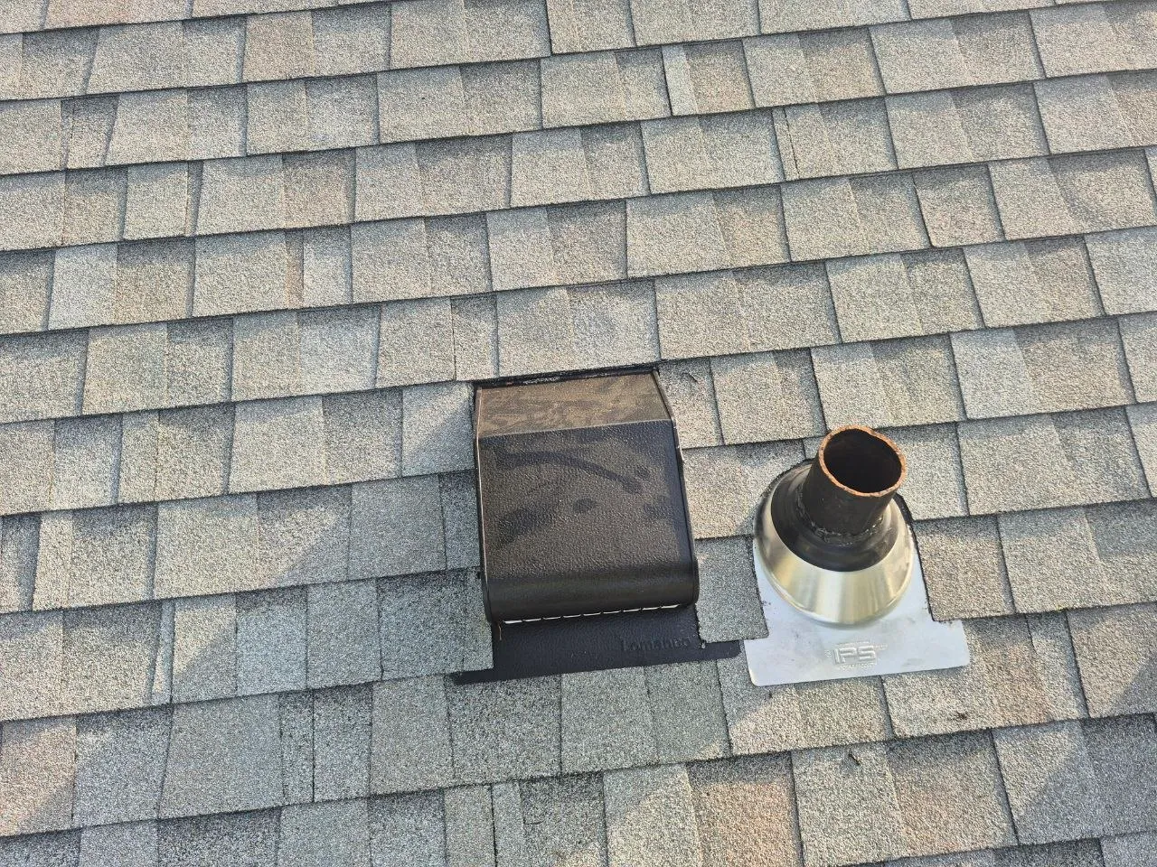 Roof vent and rubber pipe boot on an asphalt shingle roof in St. Louis, MO