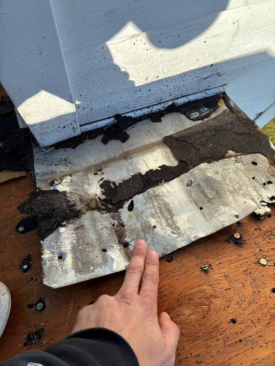 Gorilla Roofing pro showing corroded step flashing removed from a St. Louis roof