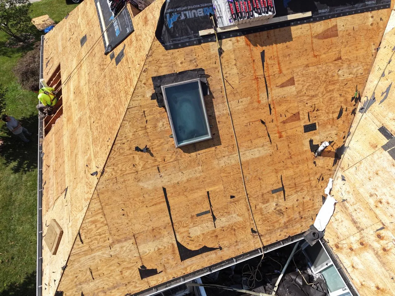Aerial view of a residential roof deck being replaced with new plywood sheathing and a skylight in St. Louis, MO.