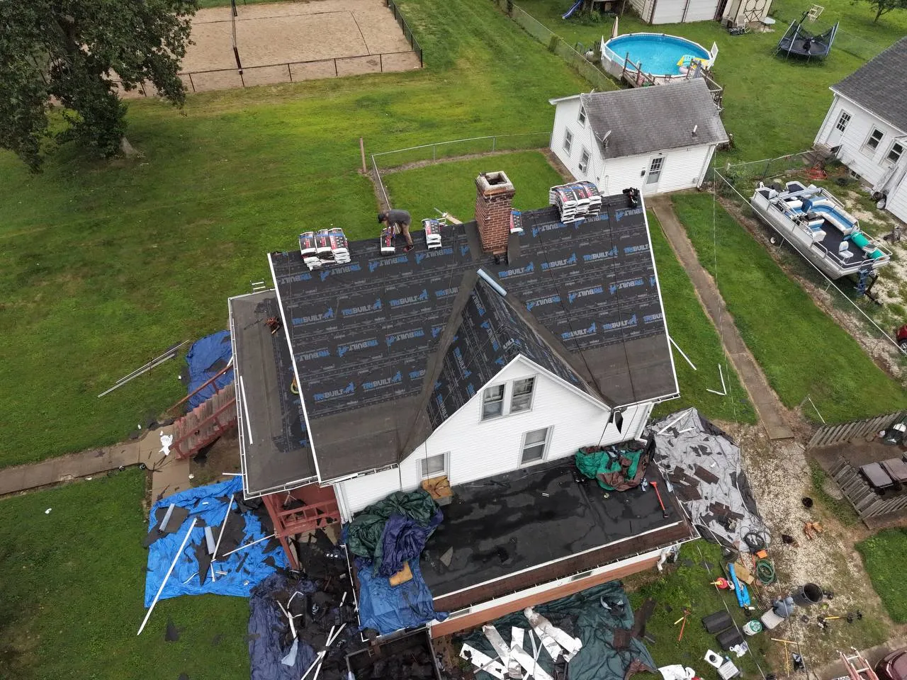 Aerial drone view of residential roof replacement in progress with TruBuilt underlayment installed in St. Louis area.