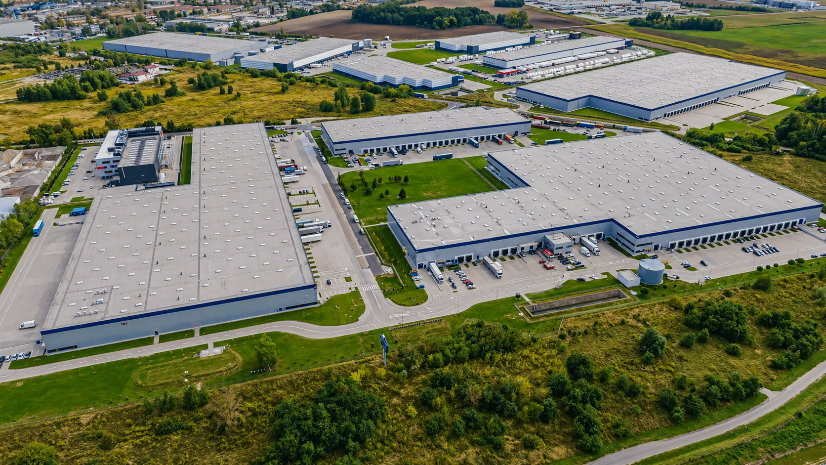 Aerial view of a commercial warehouse complex with flat TPO roofs