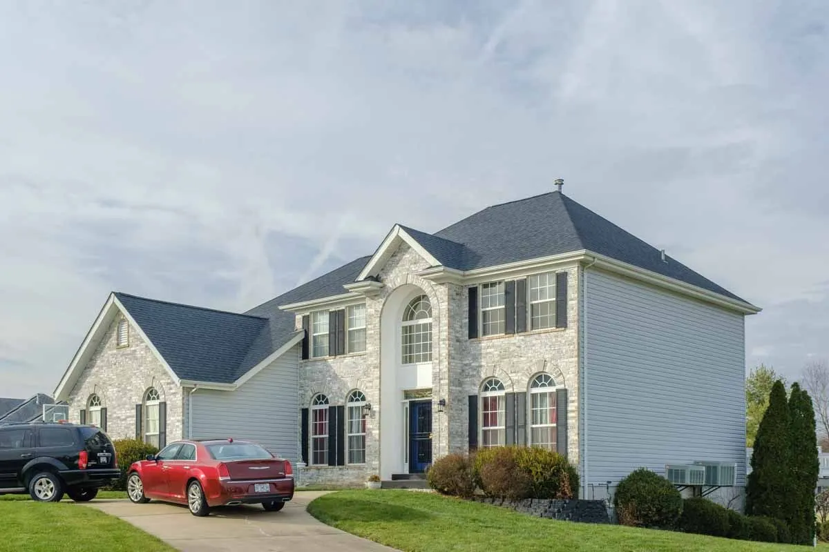 Two-story colonial home in St. Louis with white vinyl siding