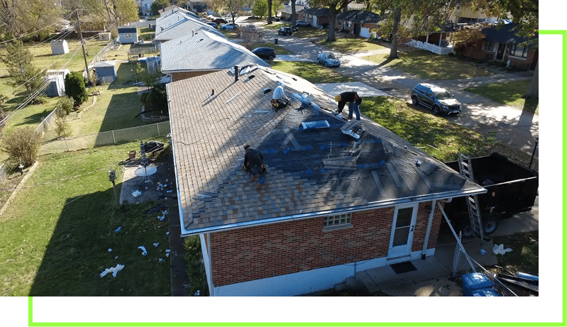 Aerial drone view of roofers installing shingles on a brick ranch home in a St. Louis residential neighborhood.