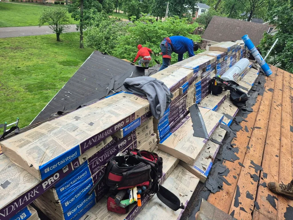 Roofing crew installing CertainTeed Landmark Pro shingles on a residential roof in St. Louis, MO